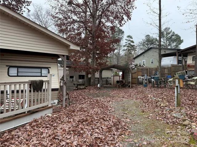a backyard of a house with bicycles parked and a tree