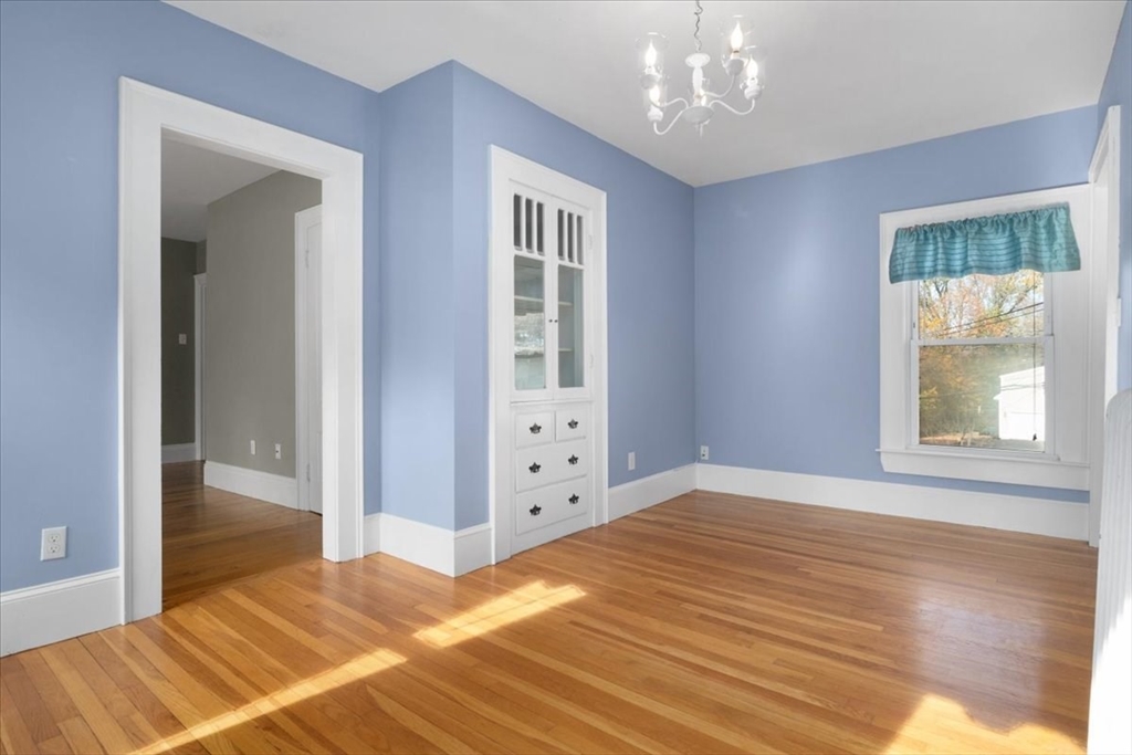 33 Dunbar Street, Unit 33 Canton, MA 02021 - Photo 12 of 42 a view of an empty room with window and wooden floor