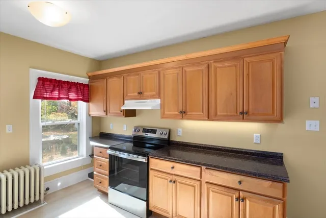 a kitchen with stainless steel appliances granite countertop a sink stove and cabinets