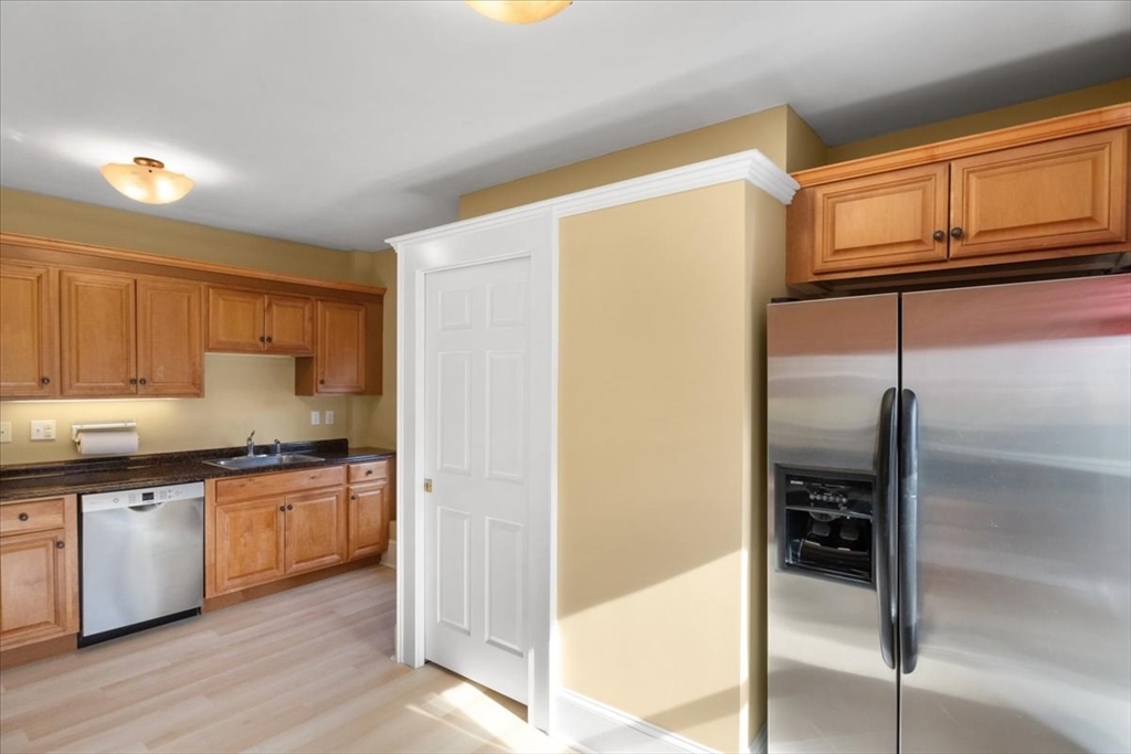 33 Dunbar Street, Unit 33 Canton, MA 02021 - Photo 18 of 42 a kitchen with stainless steel appliances granite countertop a refrigerator and a stove top oven