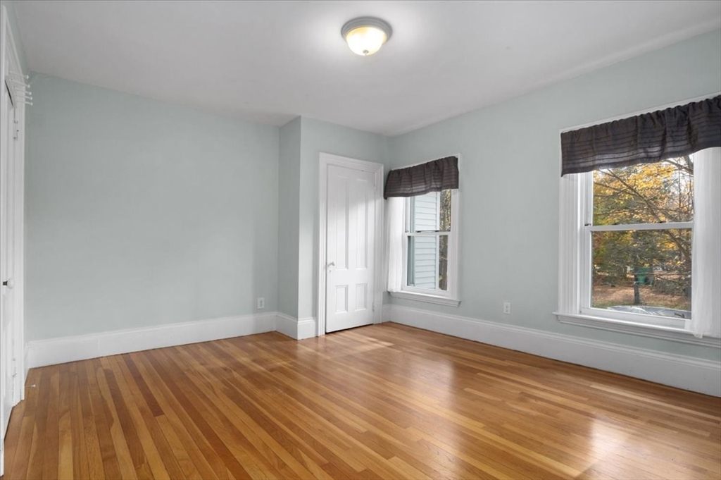 33 Dunbar Street, Unit 33 Canton, MA 02021 - Photo 23 of 42 a view of empty room with wooden floor and fan