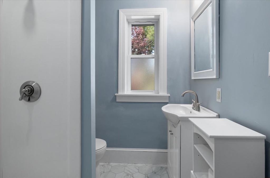33 Dunbar Street, Unit 33 Canton, MA 02021 - Photo 26 of 42 a bathroom with a sink and a mirror