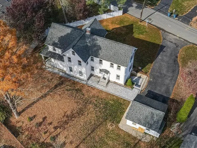an aerial view of a house with a yard