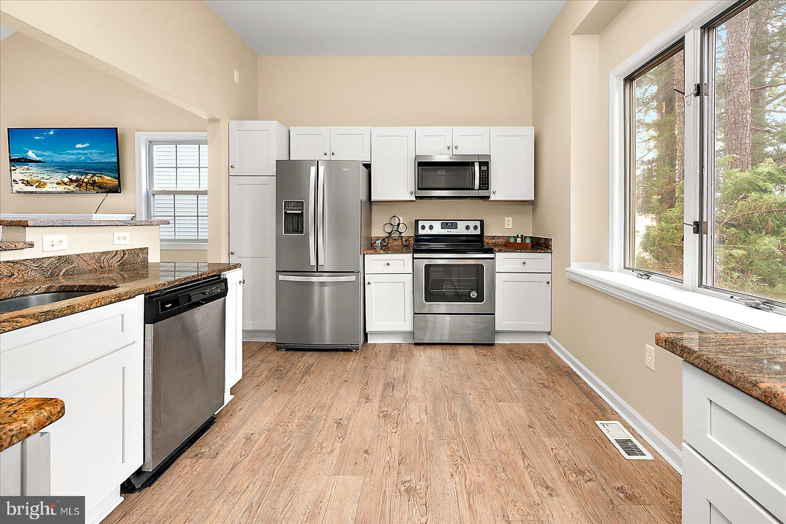 37 Watertown Road Ocean Pines, MD 21811 - Photo 13 of 86 a kitchen with white cabinets appliances and wooden floor