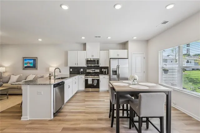 a kitchen with a sink stove and microwave