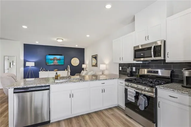 a white toilet sitting next to a bathroom sink