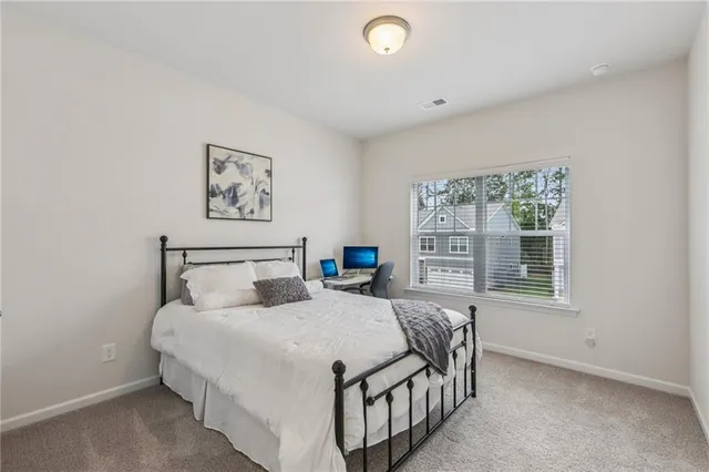 a bedroom with a bed and a desk