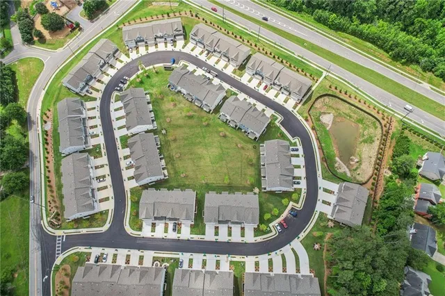 an aerial view of a swimming pool with a yard
