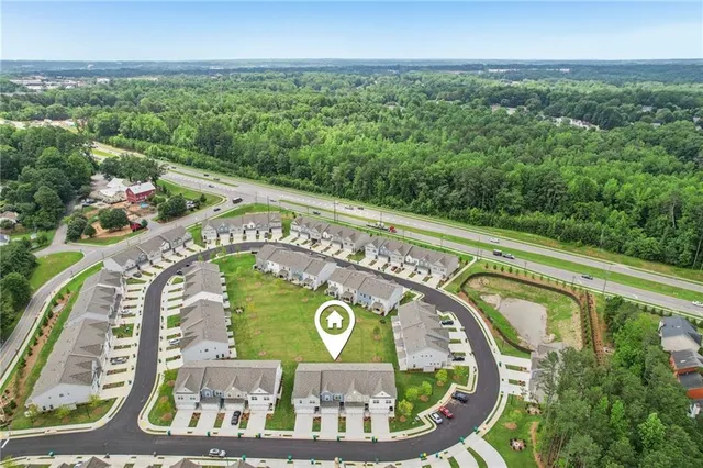an aerial view of residential houses with outdoor space