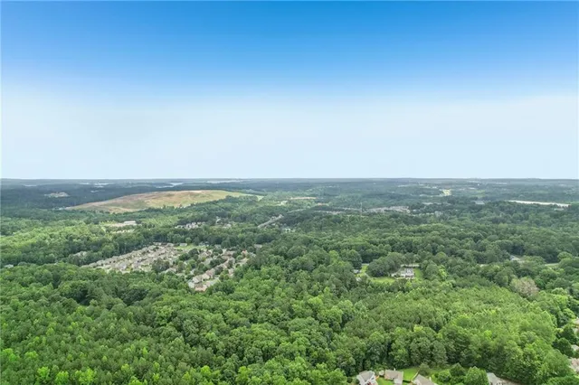 a view of a house with a backyard and a patio