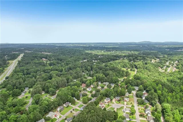 a view of a house with a yard and sitting area