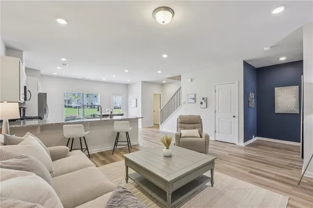 a living room with furniture and a wooden floor