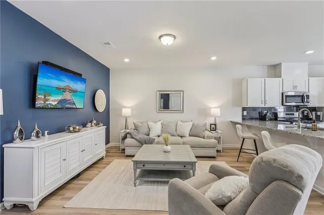 a living room with furniture and wooden floor