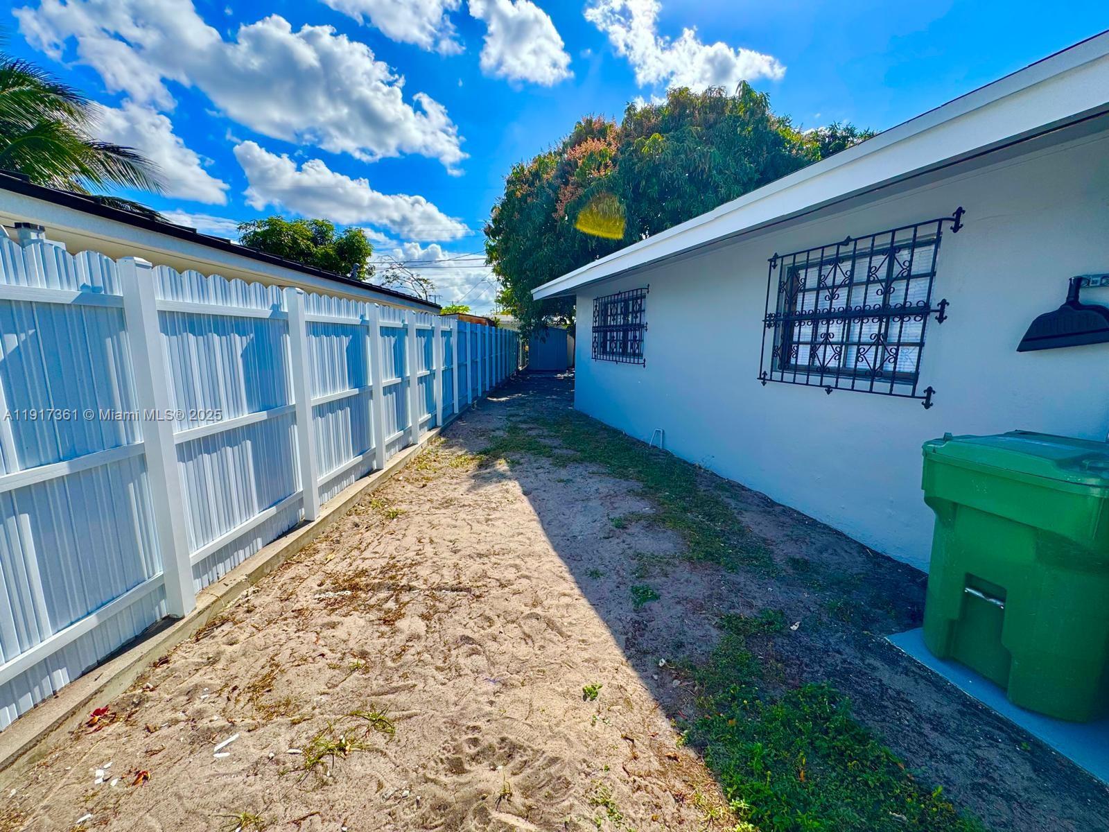 830 Southeast 7th Place Hialeah, FL 33010 - Photo 15 of 19 a view of a backyard with wooden fence and large trees