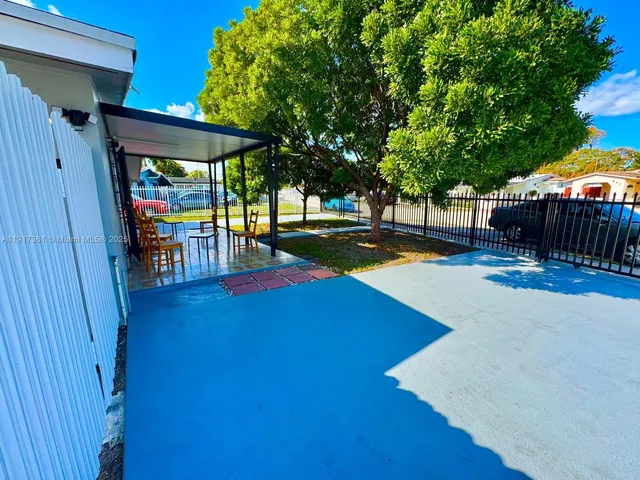 a view of swimming pool with a table and chairs under an umbrella