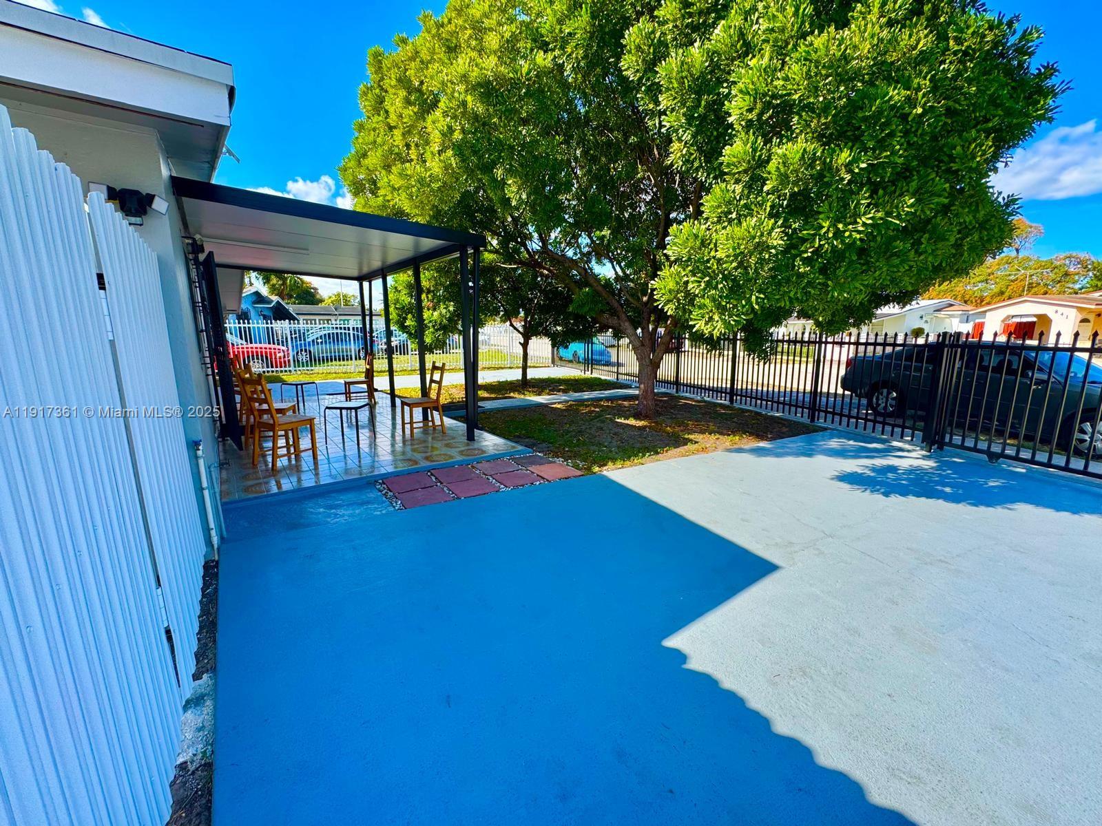 830 Southeast 7th Place Hialeah, FL 33010 - Photo 16 of 19 a view of swimming pool with a table and chairs under an umbrella