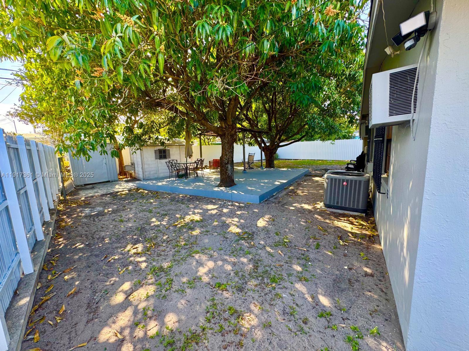 830 Southeast 7th Place Hialeah, FL 33010 - Photo 19 of 19 a backyard of a house with barbeque oven and outdoor seating