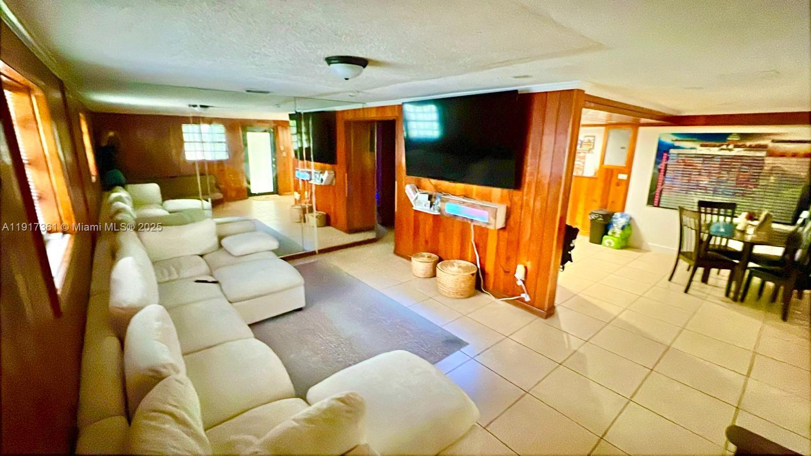 830 Southeast 7th Place Hialeah, FL 33010 - Photo 5 of 19 a living room with furniture and a flat screen tv