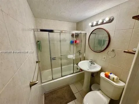 a bathroom with a sink mirror toilet and shower