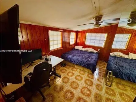 a bed room with a bed and a television