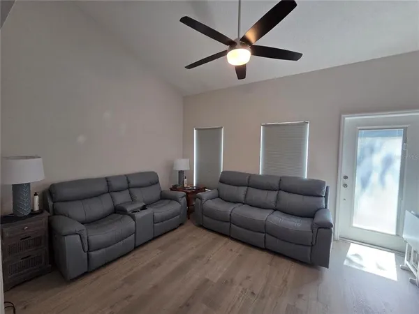 a living room with painting on the wall and a dresser