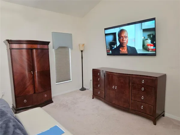 a bedroom with a bed and a mirror
