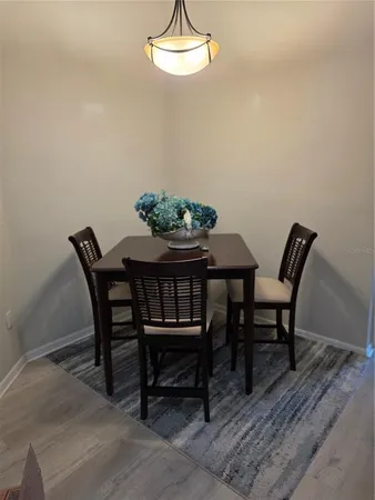 a dining room with furniture and wooden floor