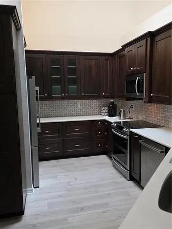 a kitchen with a refrigerator and a sink