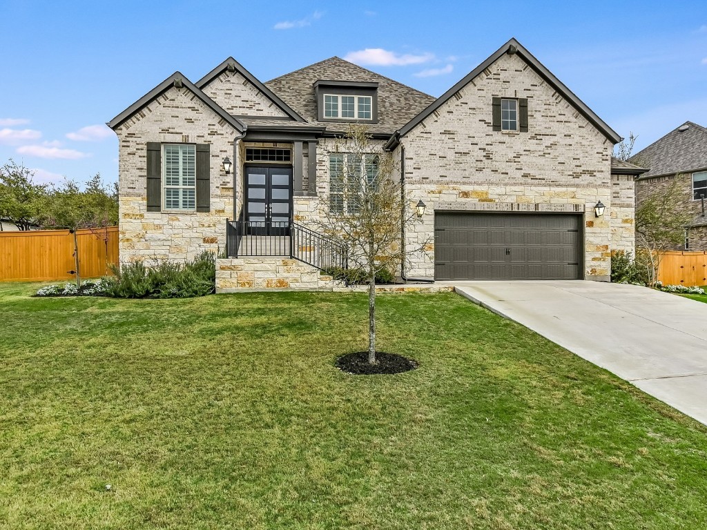 237 Rocky Spot Drive Austin, TX 78737 - Photo 1 of 1 a front view of a house with yard and garage