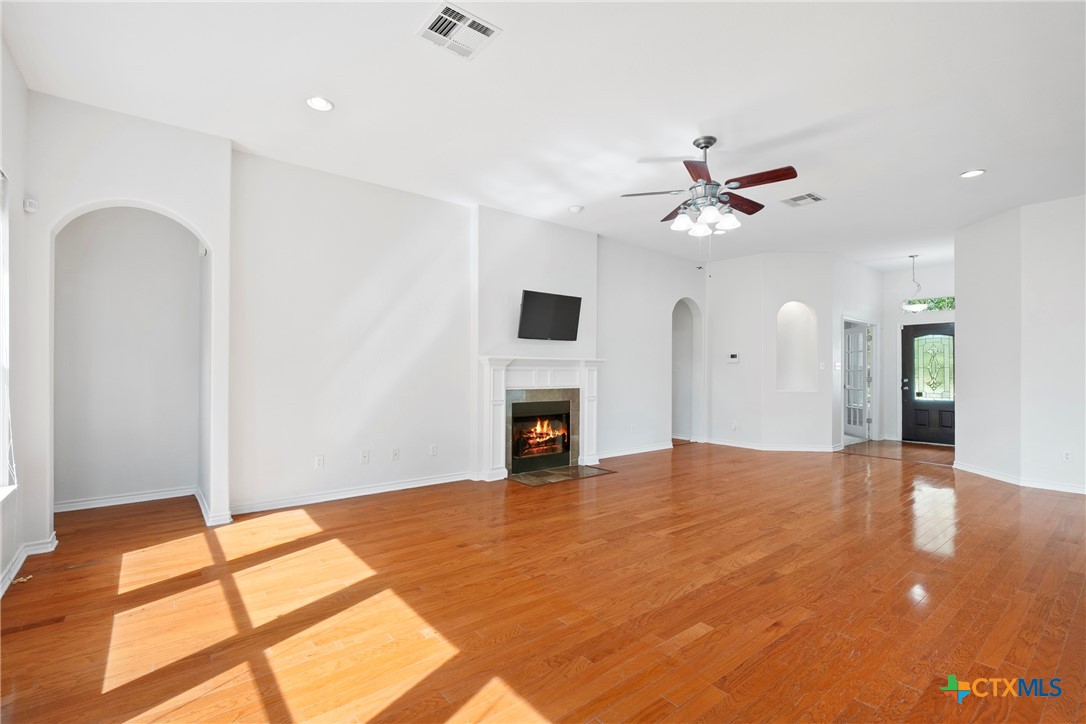 12312 Blackberry Road Salado, TX 76571 - Photo 12 of 46 a view of an empty room with a fireplace and a window