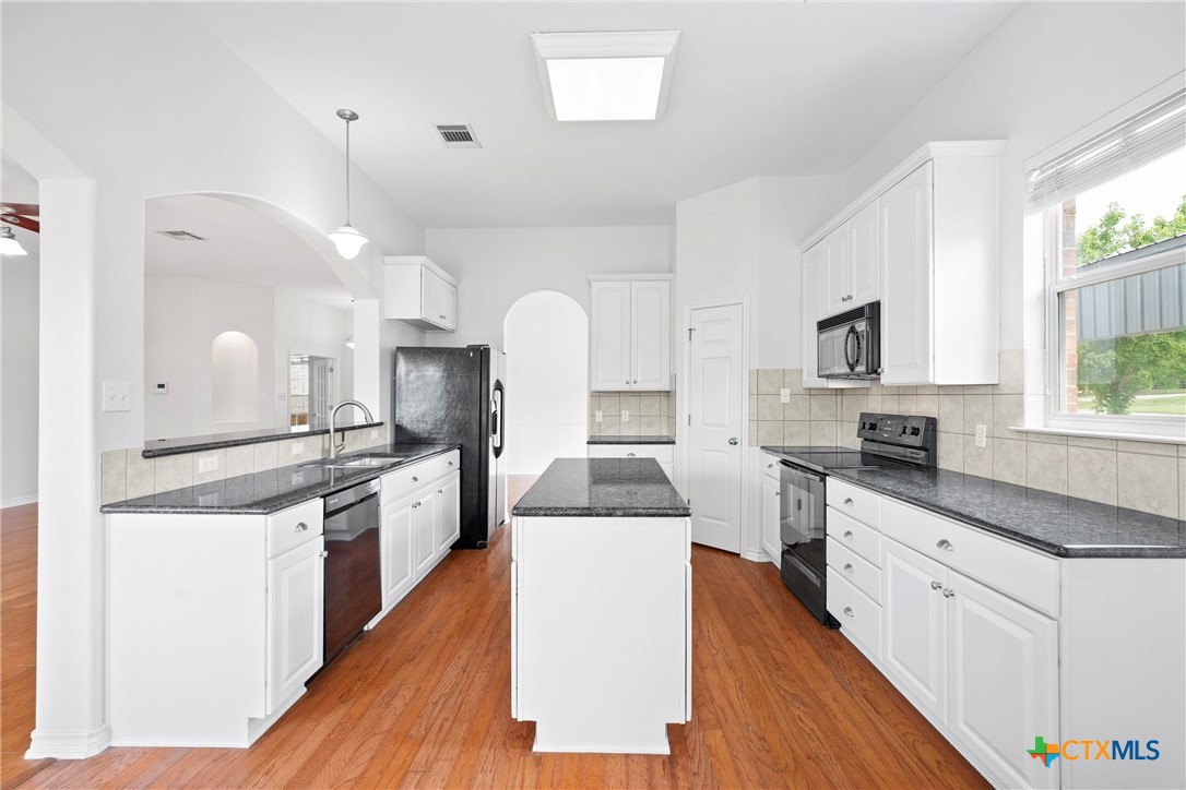 12312 Blackberry Road Salado, TX 76571 - Photo 14 of 46 a large kitchen with stainless steel appliances and white cabinets
