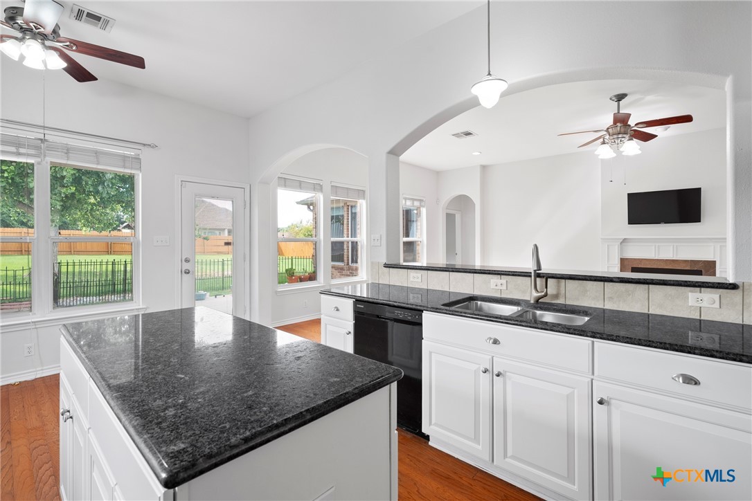 12312 Blackberry Road Salado, TX 76571 - Photo 15 of 46 a kitchen with stainless steel appliances granite countertop a sink a center island and living room view