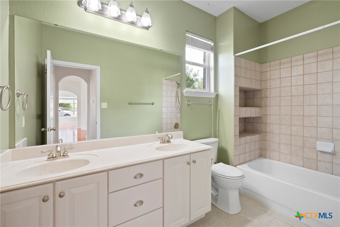 12312 Blackberry Road Salado, TX 76571 - Photo 20 of 46 a bathroom with a double vanity sink a toilet a mirror and shower