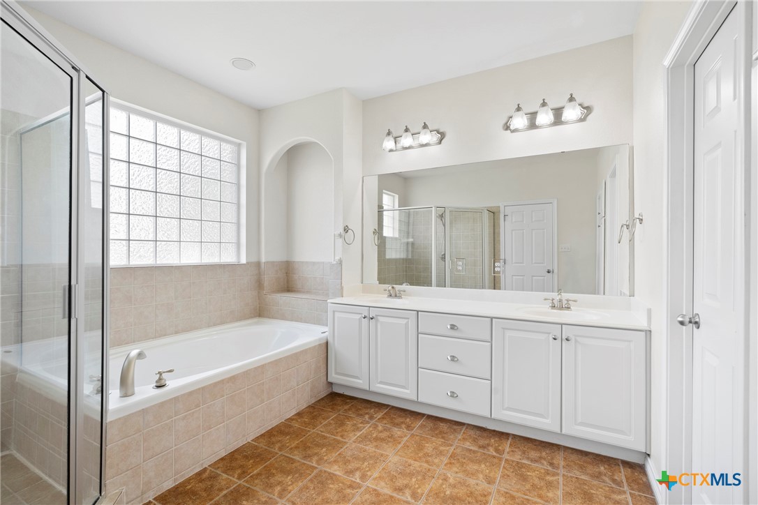 12312 Blackberry Road Salado, TX 76571 - Photo 24 of 46 a bathroom with a tub a sink and a window