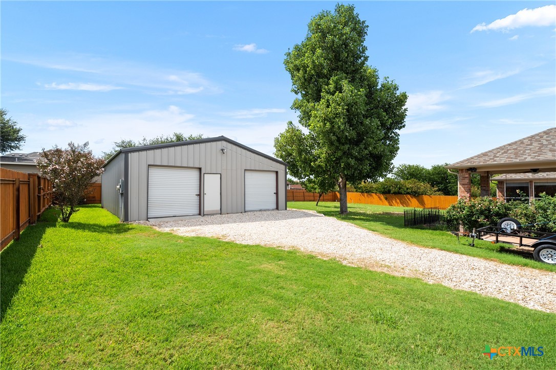 12312 Blackberry Road Salado, TX 76571 - Photo 32 of 46 a white house with green field plants and large trees