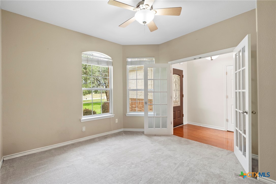 12312 Blackberry Road Salado, TX 76571 - Photo 8 of 46 an empty room with windows and fan