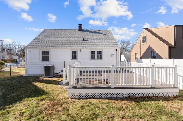 a view of a house with a wooden fence