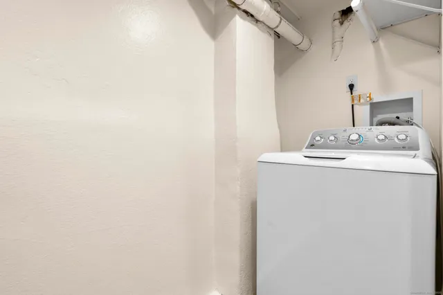 a white toilet sitting next to a white sink