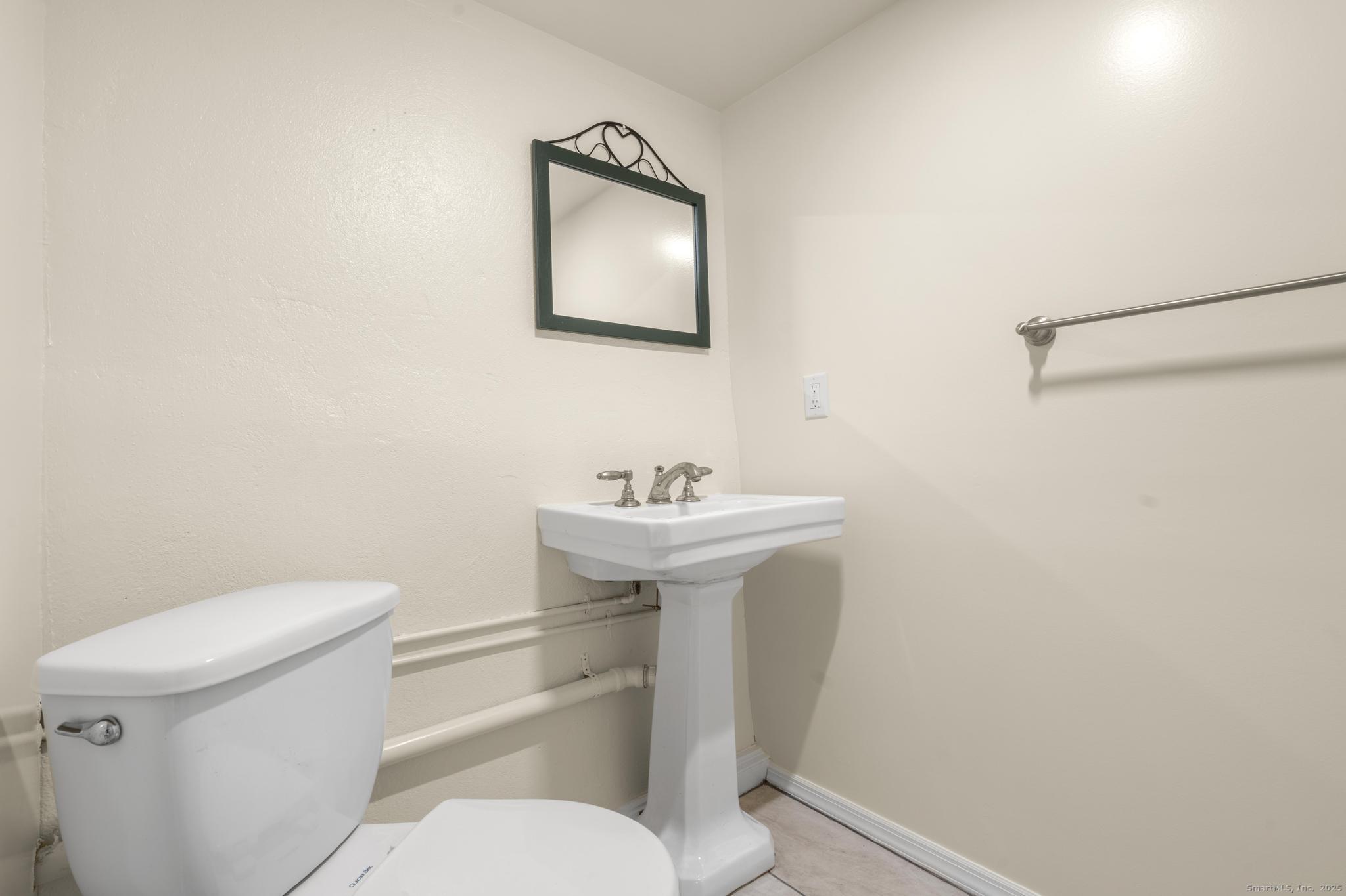 16 Silk Street Norwalk, CT 06850 - Photo 30 of 34 a white toilet sitting next to a white sink