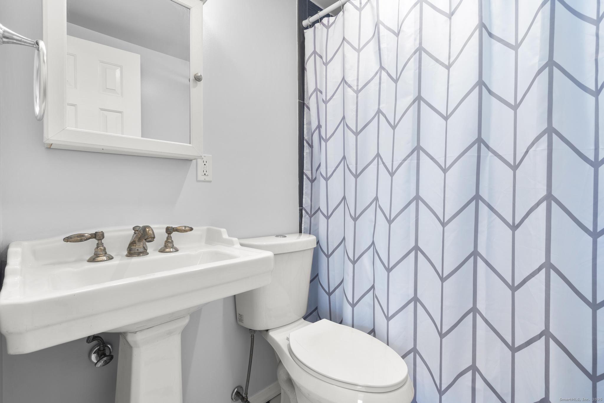 16 Silk Street Norwalk, CT 06850 - Photo 6 of 34 a bathroom with a sink a toilet and a mirror