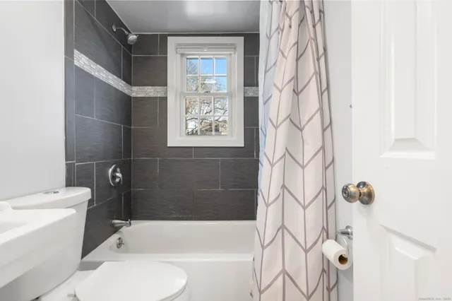 a bathroom with a toilet and shower