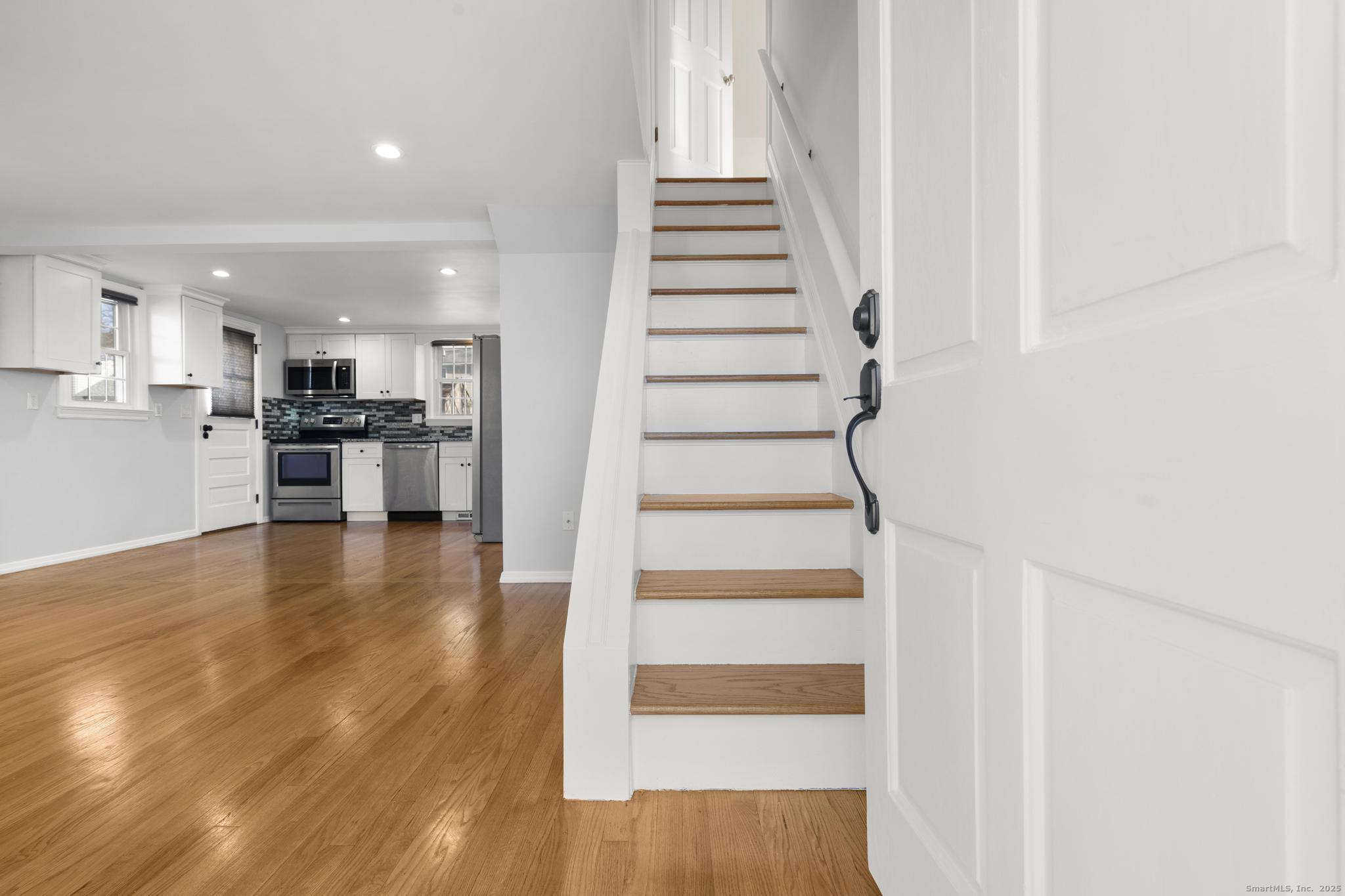16 Silk Street Norwalk, CT 06850 - Photo 9 of 34 a view of entryway and kitchen with wooden floor