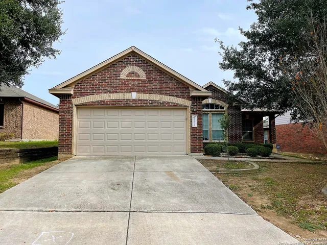 a view of a house with a yard and garage