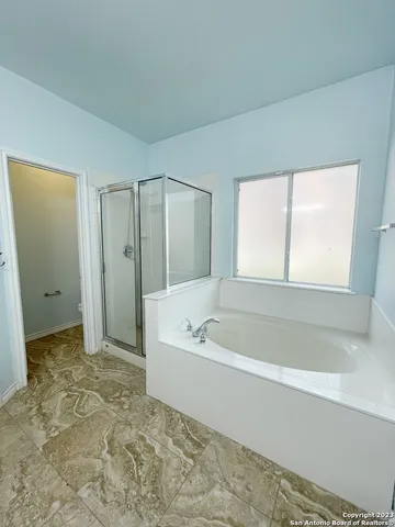 a bathroom with a bathtub and a shower