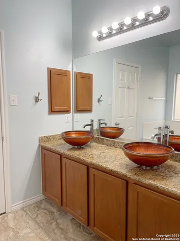a bathroom with sinks and a mirror