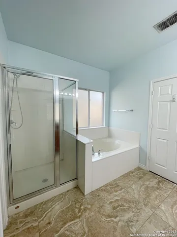 a bathroom with a bathtub and a shower