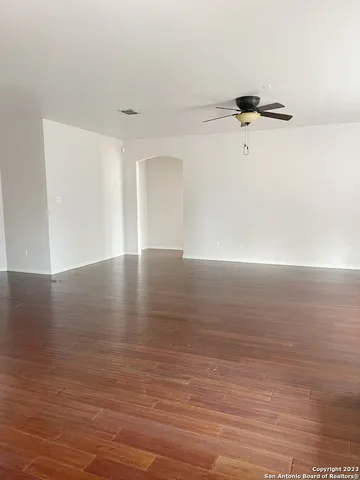 a view of a room with wooden floor