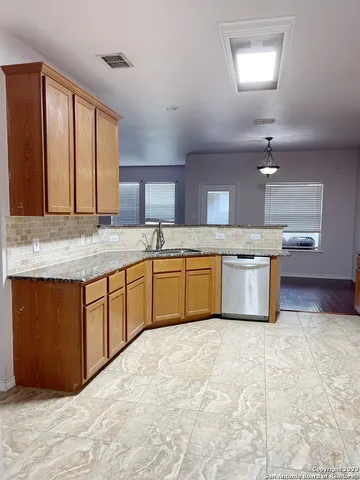 a kitchen with a sink stove and cabinets