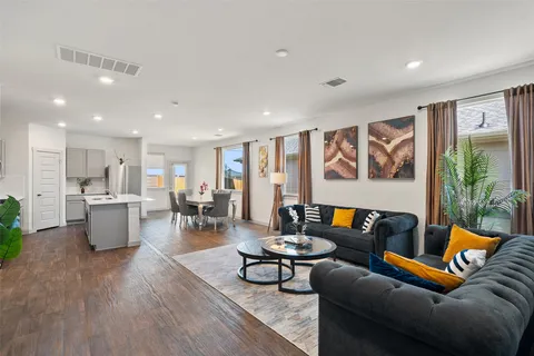 a living room with furniture and kitchen view