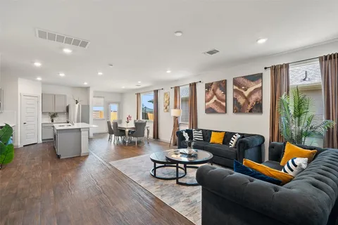 a living room with furniture and kitchen view